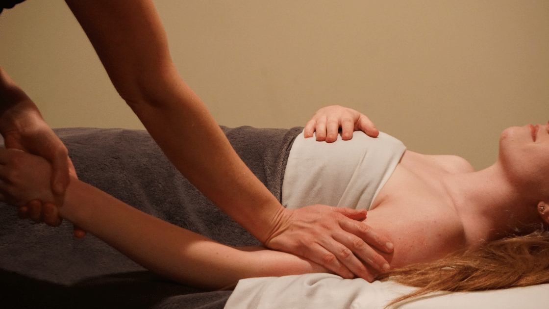 girl receiving cbd massage with hands on arm