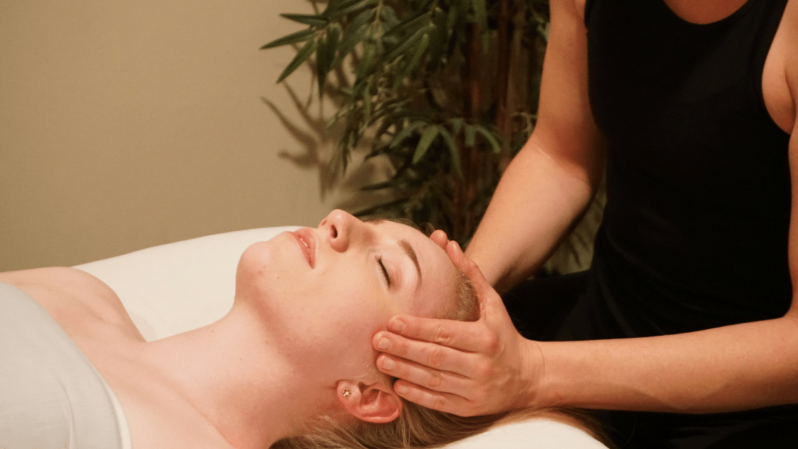 girl getting signature massage with hands on head