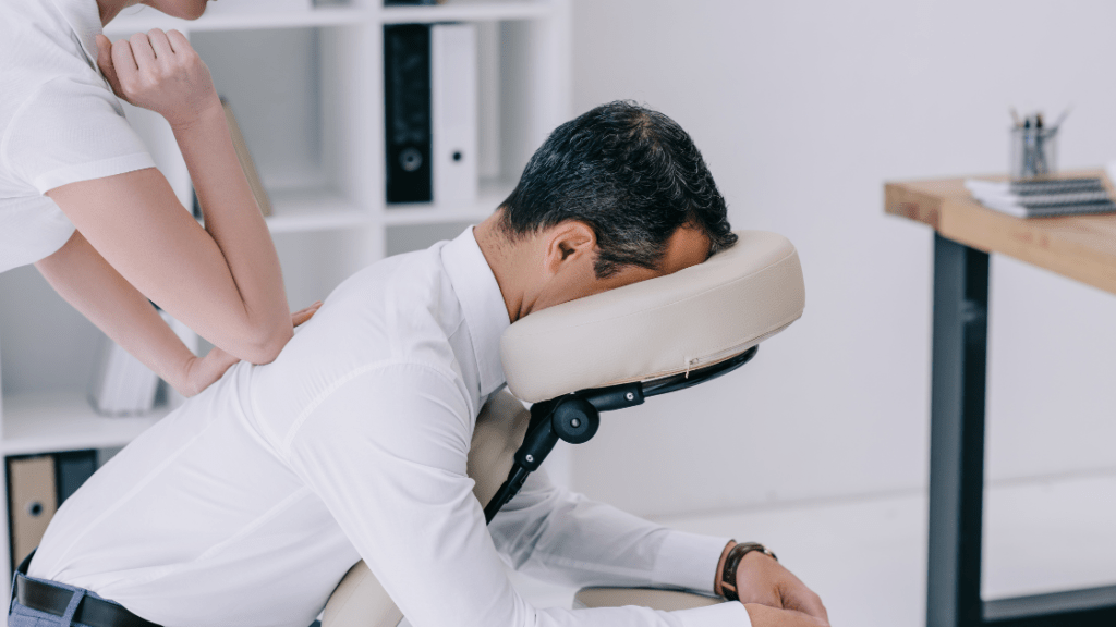 man receiving corporate chair massage