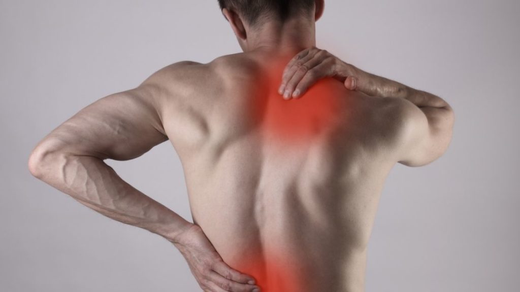man grabbing back with muscular pain