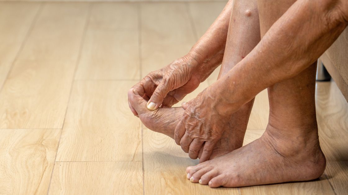 person grabbing foot in pain with gout