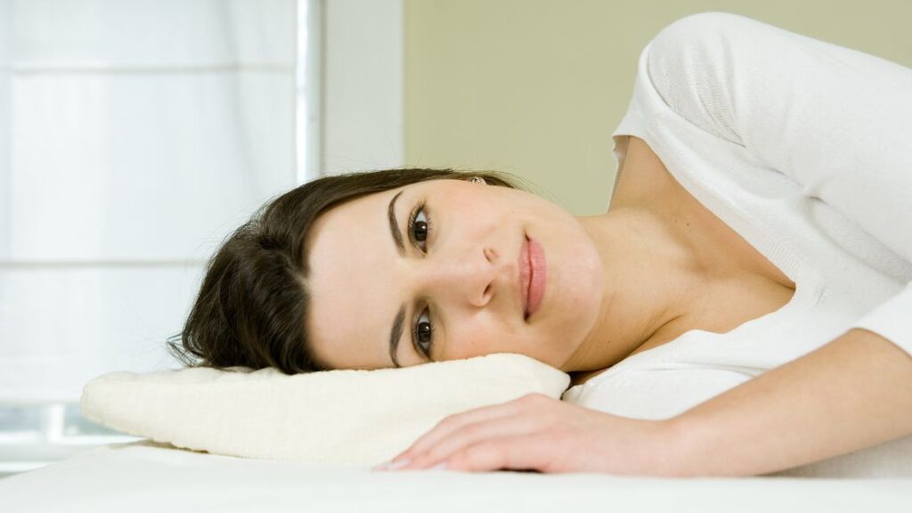 woman laying on a pillow on her side