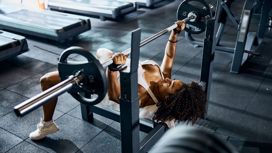woman doing a bench press in the gym