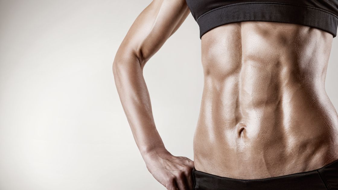 woman in black workout clothes, close up of her abs