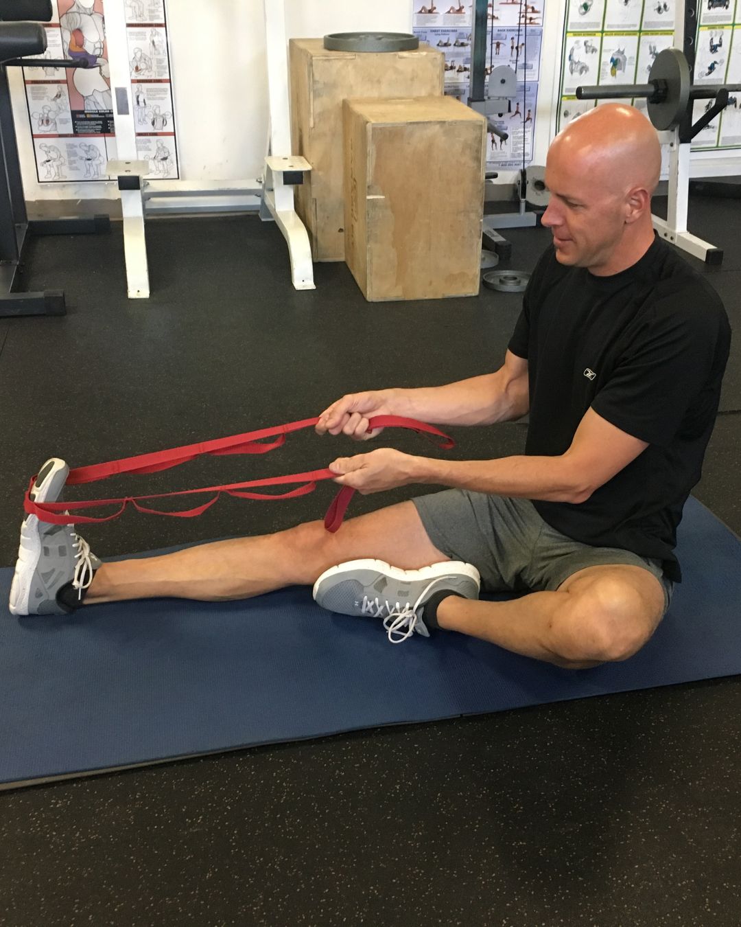 Dr. Moyer stretching out calf with red strap