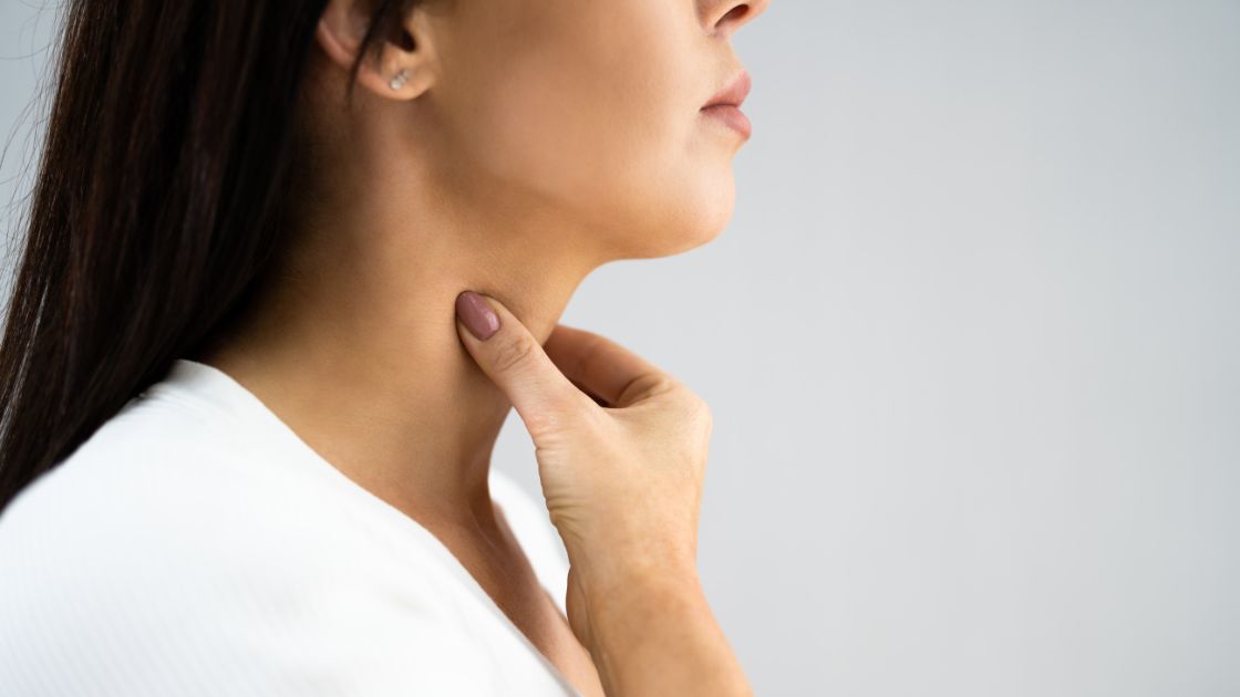 side view close up of woman grabbing throat