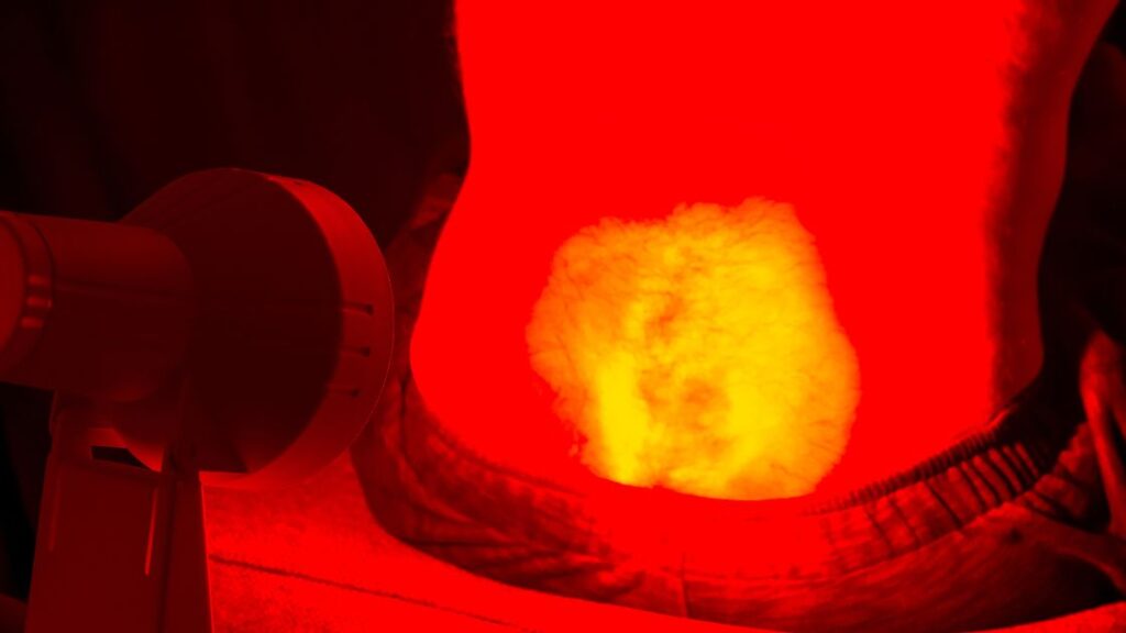 red light therapy on person's lower back