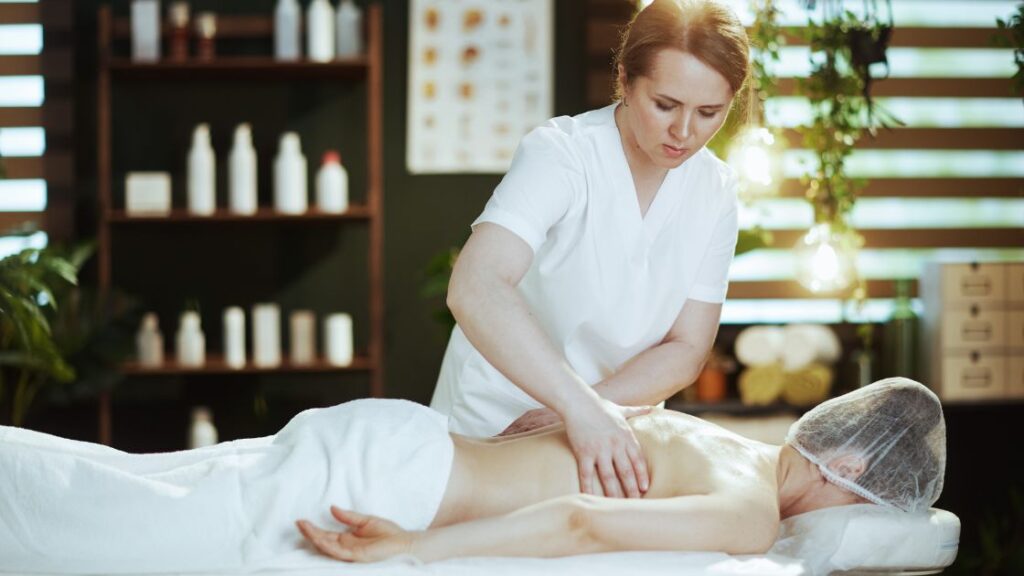 medical massage therapist performing massage on patient's back