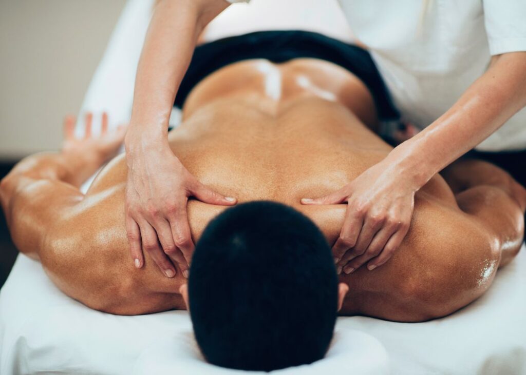man receiving sports massage on his back