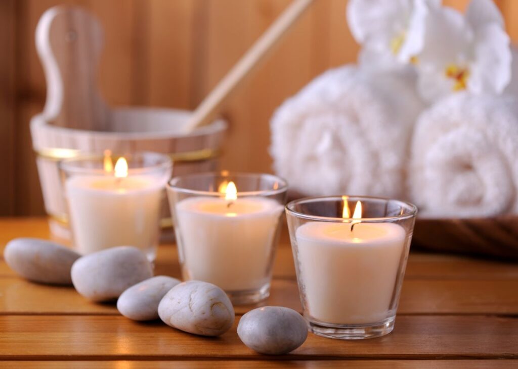 candles, rocks, and towels in a relaxing sauna
