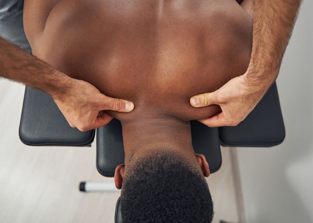 man getting a trigger point massage on traps