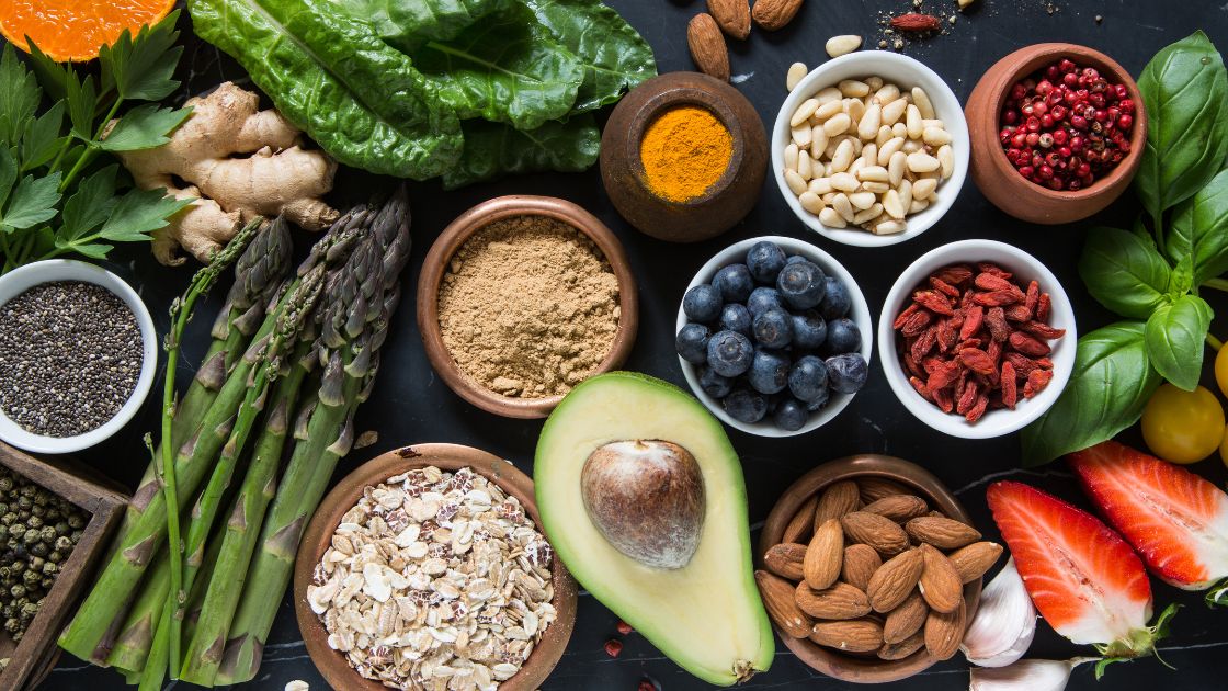 Healthy food, fruits, vegetables, and nuts laid out on a table