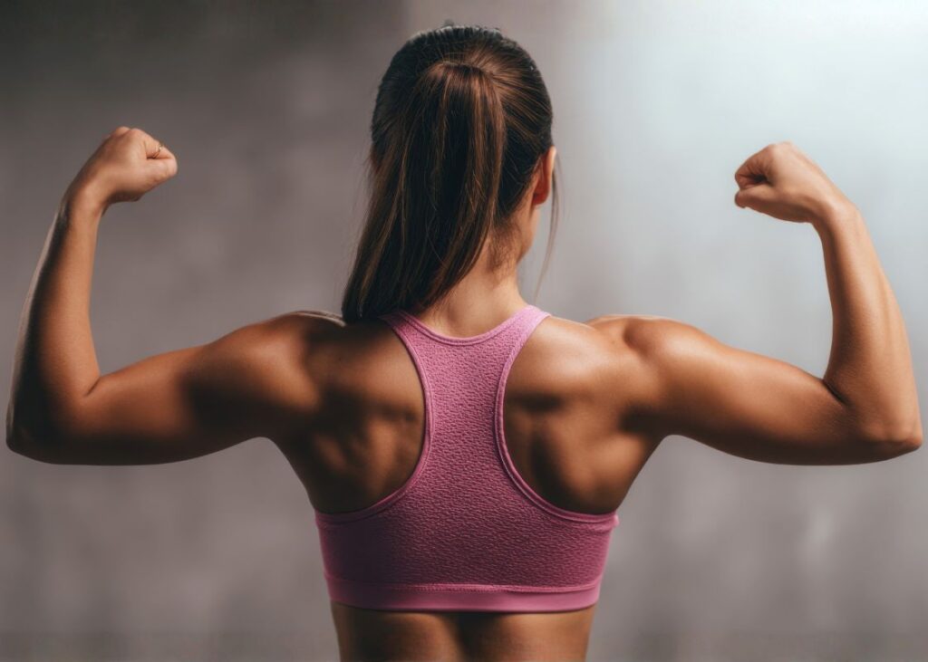 woman in pink top flexing