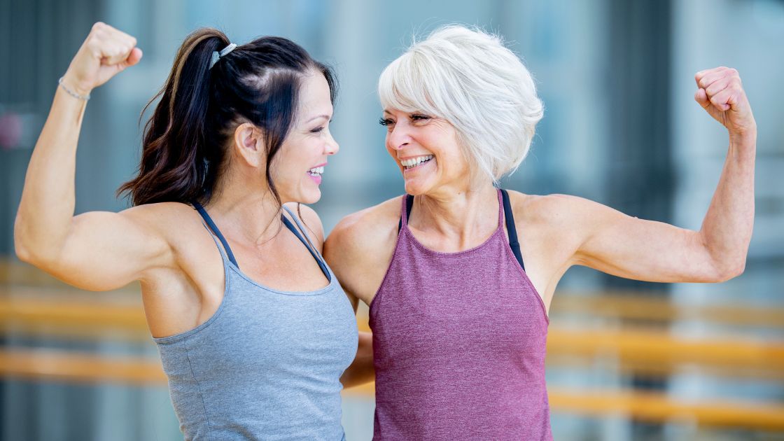 two women flexing together after a workout class