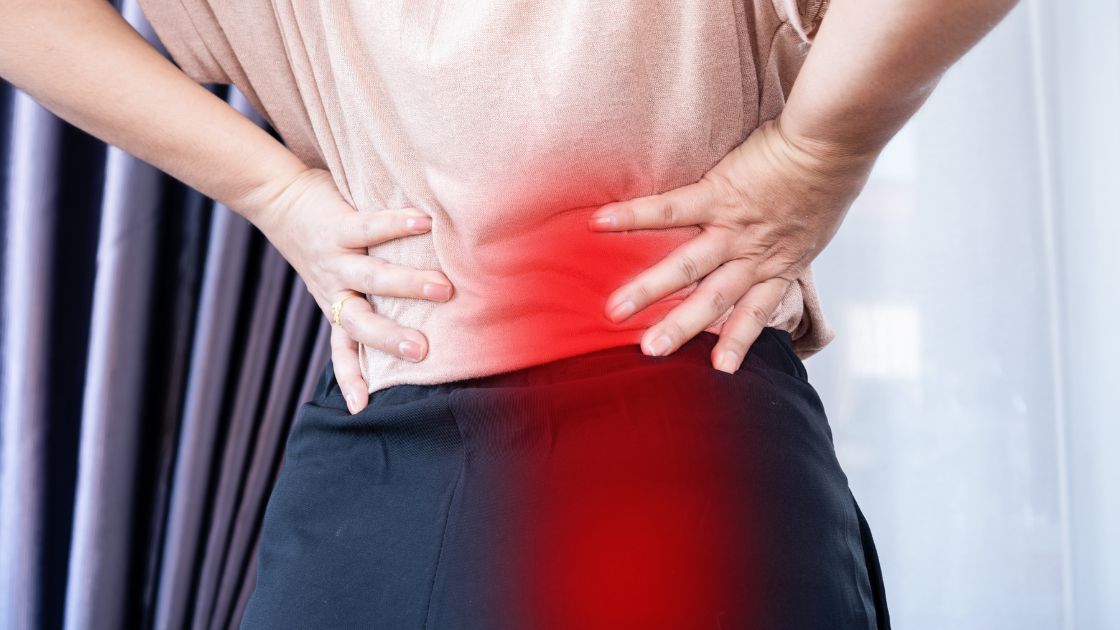 woman with highlighted red pain spot on lower back for sciatica pain